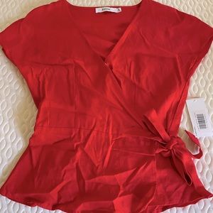Red wrap shirt, peplum bottom, bow at waist